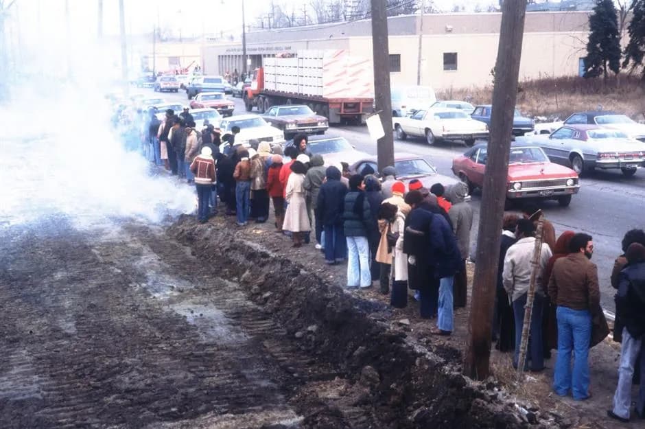 A long unemployment line stretching down a roadside
